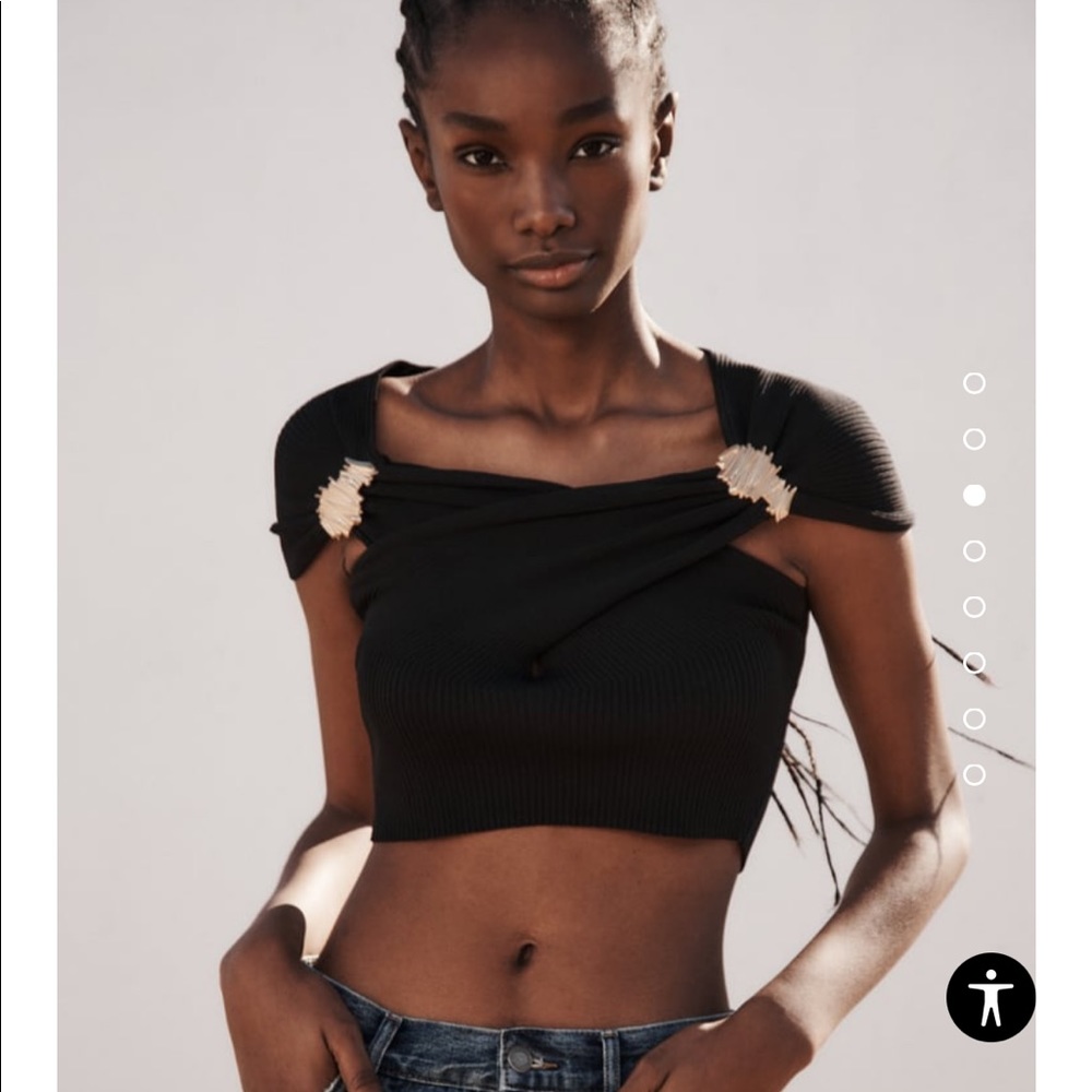 New black knit crop sweater with gold brooch